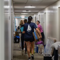 Group of people in the hallway with their stuff